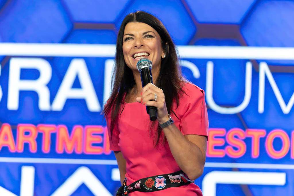 Keynote speaker on stage at a corporate conference